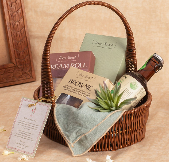 Wicker basket with a bottle, napkins, and a card on a beige surface.